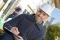 builder in hardhat with clipboard outdoors Royalty Free Stock Photo