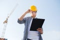 Builder in hardhat with clipboard outdoors Royalty Free Stock Photo