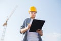 Builder in hardhat with clipboard outdoors Royalty Free Stock Photo