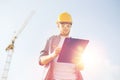 Builder in hardhat with clipboard outdoors Royalty Free Stock Photo