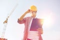 Builder in hardhat with clipboard outdoors Royalty Free Stock Photo