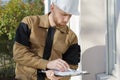 Builder in hardhat with clipboard and pencil outdoors Royalty Free Stock Photo