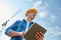 Builder in hardhat with tablet pc at construction Royalty Free Stock Photo