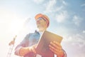 Builder in hardhat with tablet pc at construction Royalty Free Stock Photo