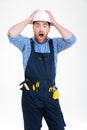 Builder in helmet staning with mouth opened Royalty Free Stock Photo