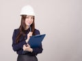 Builder in helmet writes pencil folder