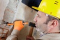 builder hitting wall with hammer Royalty Free Stock Photo