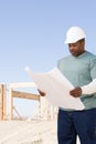 A builder holding a blueprint Royalty Free Stock Photo