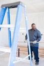 A builder holding a plank of wood Royalty Free Stock Photo