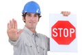 Builder holding stop sign Royalty Free Stock Photo