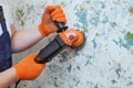 The builder holds in hands Angle grinder. Royalty Free Stock Photo