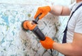 The builder holds in hands Angle grinder. Repair work. Royalty Free Stock Photo