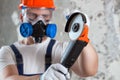 The builder holds in hands Angle grinder. Repair work, interior decoration of walls Royalty Free Stock Photo