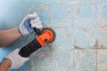 The builder holds in hands Angle grinder. Repair work, interior decoration of walls Royalty Free Stock Photo