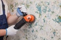 The builder holds in hands Angle grinder. Repair work, interior decoration of walls Royalty Free Stock Photo