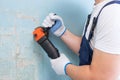 The builder holds in hands Angle grinder. Repair work, interior decoration of walls Royalty Free Stock Photo