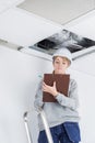 Builder inspecting roof damage Royalty Free Stock Photo