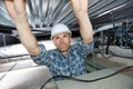 Builder during installation process false ceiling Royalty Free Stock Photo
