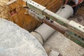 Builder installing big diameter concrete drainage pipe protected by trench support system during deep drainage works Royalty Free Stock Photo