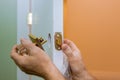 Builder in installing a door lock the door of a new house Royalty Free Stock Photo