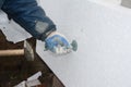 Builder installing rigid styrofoam insulation board for energy s