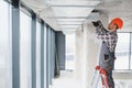 Builder installing ventilation system in modern office building Royalty Free Stock Photo
