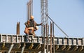 Builder installs formwork and iron reinforcement or reinforcing bar for reinforced concrete partitions Royalty Free Stock Photo