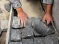 The builder installs a granite bricks on the path - a top view Royalty Free Stock Photo