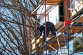 Builder installs an insulating plate from for energy saving. The concept of heat saving during the crisis Royalty Free Stock Photo