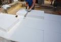 Builder insulating house foundation floor with rigid foam board insulation for warm floor