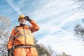 Builder knocking down road setting out steel pins with lump hammer during roadworks. Builder hammering steel bars down into the