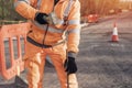 Builder knocking down road setting out steel pins with lump hammer during roadworks. Builder hammering steel bars down into the