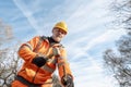 Builder knocking down road setting out steel pins with lump hammer during roadworks. Builder hammering steel bars down into the