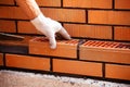 Builder laying bricks on construction site Royalty Free Stock Photo