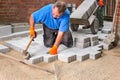 Builder laying new paving stones.