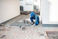 Builder laying paving tiles Royalty Free Stock Photo