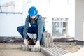 Builder laying paving tiles Royalty Free Stock Photo