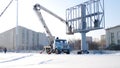 Builder on a Lift Platform at a construction site. Men at work. construction worker assembling scaffold on building site