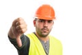 Builder male wearing helmet and vest showing dislike thumb-down