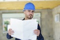 Builder man checks project Royalty Free Stock Photo