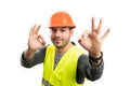 Builder man with happy expression making double okay gesture