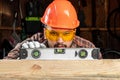 Builder man looks at the construction level checks the horizontal surface, male hands with a level close-up. Construction work, Royalty Free Stock Photo