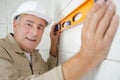 Builder man working confident measuring and leveling wall