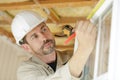 Builder measuring window using tape measure and pencil Royalty Free Stock Photo