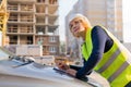 A woman Builder at a construction site inspects a house made of brick Royalty Free Stock Photo