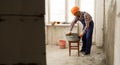 builder mixing mortar to install bricks block on construction site, repair house concept. Royalty Free Stock Photo