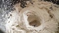 Builder mixing tile glue in a bucket using an electric mixer. Mixing solution in a bucket, close-up. The solution in the bucket is Royalty Free Stock Photo