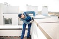 Builder mounting metal cover on the parapet of a new building