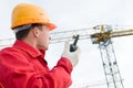 Builder operating the tower crane Royalty Free Stock Photo