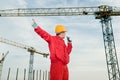 Builder operating the tower crane